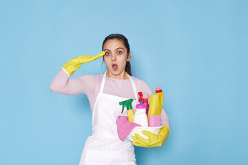 woman in gloves and cleaner apron holding bucket of detergents