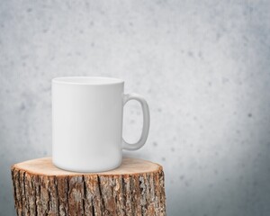 Blank ceramic cup on wooden podium