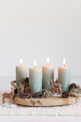 Handmade modern advent wreath with four candles lit every sunday before christmas. Traditional diy...