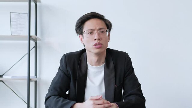 Boring information. Communication distraction. Remote interview. Business man talking showing knock gesture waving hey in office interior with free space. Long video shot.