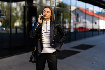 Obraz premium Attractive business woman talking on mobile phone with client.