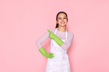 woman in rubber gloves pointing fingers aside at copyspace