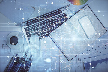 Multi exposure of data drawing hologram over topview of study desk background with computer. Concept of technology.