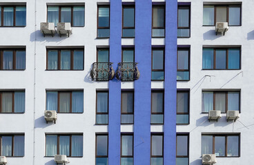 Facade of a building with an openwork forged balcony