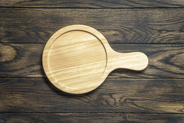 Wooden platter on oak table. Kitchen accessories for serve. Top view with copy space - 538897008