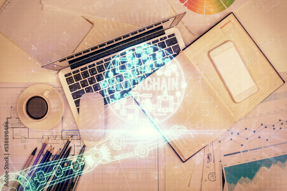 Poster blockchain theme hologram drawings over computer on the desktop background. top view. multi exposure