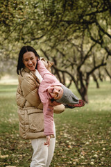 mother and daughter fooling around in the park