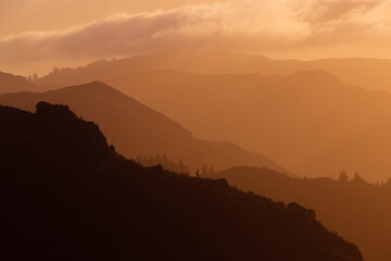 Layer of mountains under the golden sunlight.