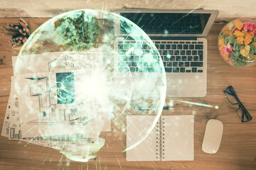 Business theme hologram drawings over computer on the desktop background. Top view. Multi exposure. Concept of international connections.