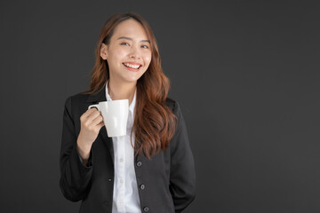 Business woman wearing a black suit Standing with a cup of coffee.