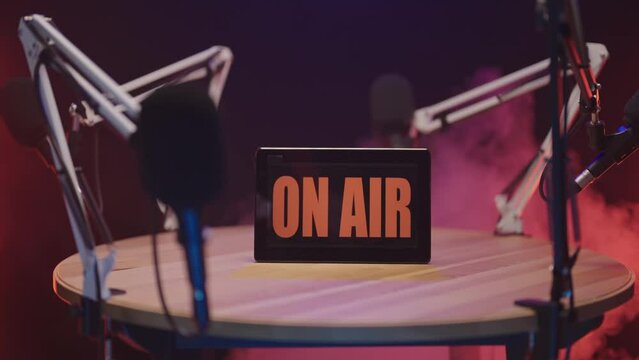 Podcast talk show black studio in smoke blast ON AIR zoom out reveal 4K