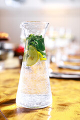 Iced lemonade pitcher, cold citrus infused water beverage with lemon, mint leaves