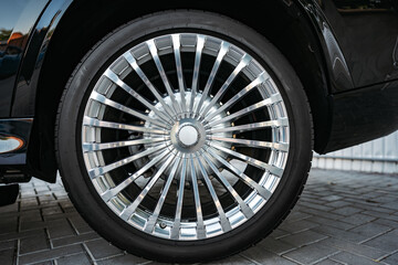 Aluminium rim of luxury black suv car wheel close up