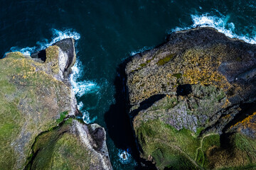 Crawton, Aberdeenshire, Scotland aerial view, bird's eye panorama by drone (sea, cliffs, waves and...