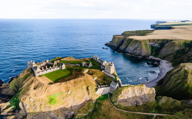 Aerial view Aberdeenshire, DUNNOTTAR CASTLE, SCOTLAND sunset, sea, rocks and cliffs made by drone, scenic panoramaold castle near Stonehaven - obrazy, fototapety, plakaty