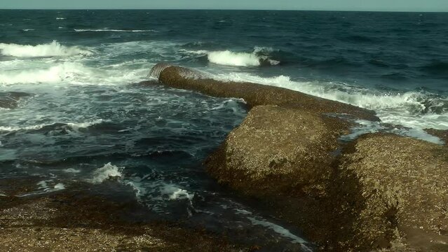 Waves crashing on rocks at Perce Beach on the Gasp&eacute; Peninsula 
Steady shot from Quebec Canada, 2021
