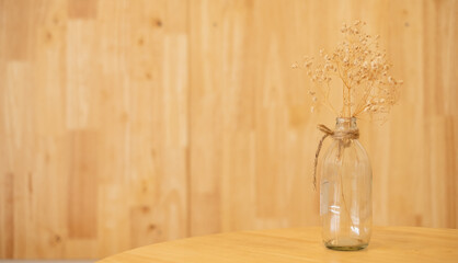 dried flowers in a glass jar vase on the table. space for text