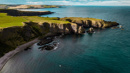 View of the coast of the sea near Dunnottar Castle, high red stone cliffs near Stonehaven (aberdeenshire)