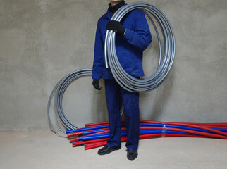 Plumber installing plastic pipes