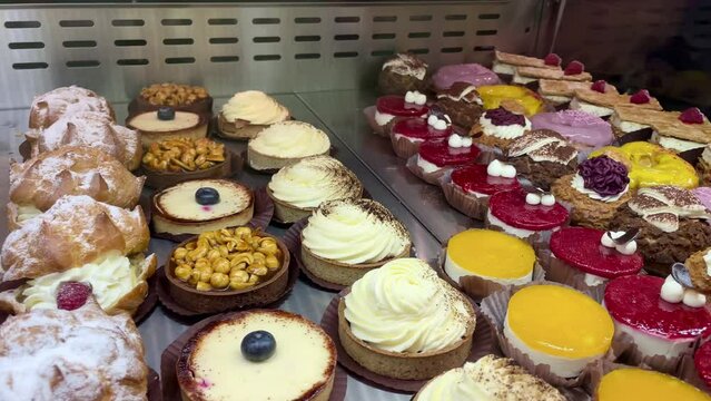 A showcase with cakes and pies. A wide variety of dessert choices in the bakery