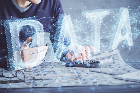 Double exposure of man's hand holding and using a digital device and data theme drawing. Technology concept.