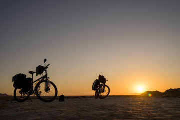 Fototapeta na wymiar Two Bicycle for travel at an amazing sunrise in the Middle East