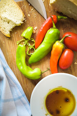 Vegetables on a wooden cutting board. Some bread aside.