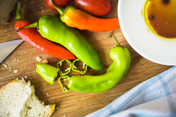 Vegetables on a wooden cutting board. Some bread aside.