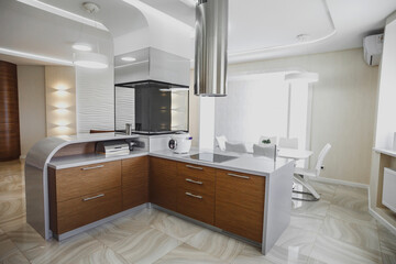 View of luxury modern fitted kitchen with stainless steel appliances