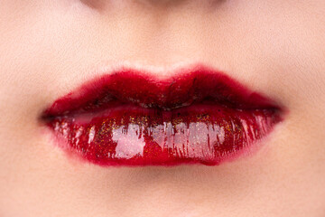 Obraz premium A woman's lips with red lipstick