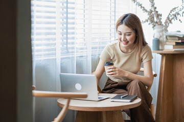 Asian women use laptops to shop online in coffee shops.
girl surfing the internet chat blogging woman looking at his laptop screen