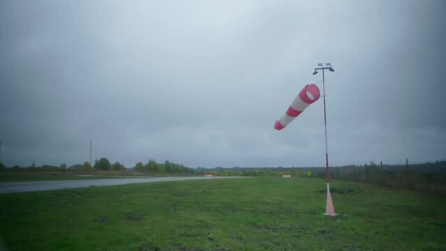 A wind flag in cloudy weather on the runway. High quality FullHD footage