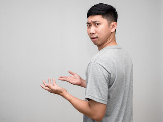 Portrait asian man grey shirt feels worried and  confused turn around to loking at you isolated