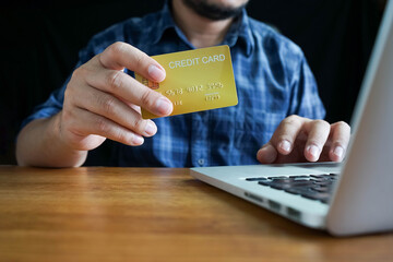 Online payment, Man's Hands holding credit card and using laptop, online credit card payment for purchases from online, Online shopping.	