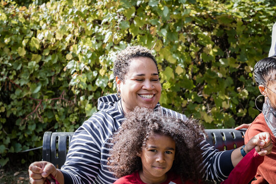 Black Auntie Laughs With Nephew In The Park 