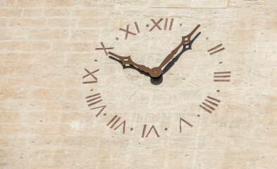 Old clock with Roman numbers engraved on the facade of the Notre-Dame-des-Anges Collegiate Church...