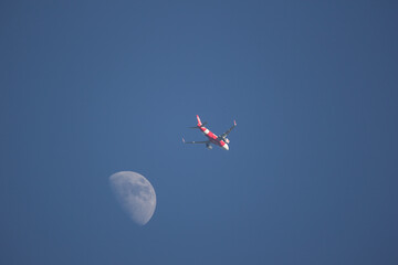 Fototapeta na wymiar Passenger Airplane and the moon
