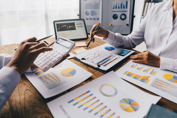 Financial analysts analyze business financial reports on digital tablets during conversations at corporate meetings, showing results of successful teamwork. business meeting ideas marketing