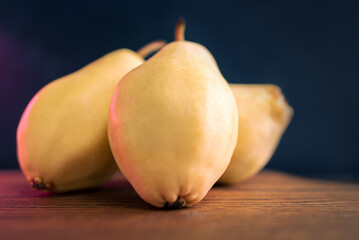Three Whole Pears Paced On A Slate Board. Healthy Food. Eco-Friendly Products. Selective Focus. Side View. Dark Background.