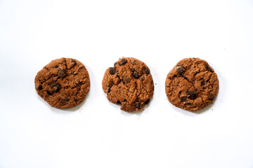 Collection of half chocolate chip cookies on white background.
