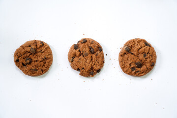 Collection of half chocolate chip cookies on white background.
