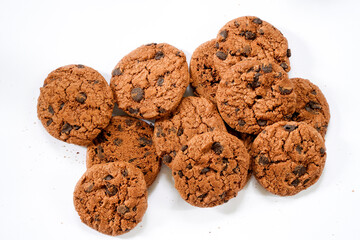 Collection of half chocolate chip cookies on white background.
