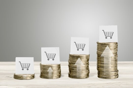 Stack of golden coins with shopping cart image
