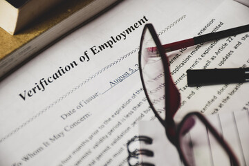 Close-up view of the Verification of Employment (VOE) form on desk. Selective focus.