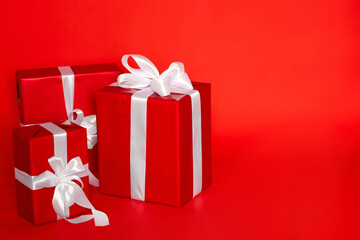 Minimal gift wrapping design for birthday or Christmas on red background. Advertising of packaging materials for holiday