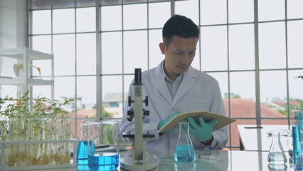 Research concept of 4k resolution. Asian scientists are searching for information from notebooks in...
