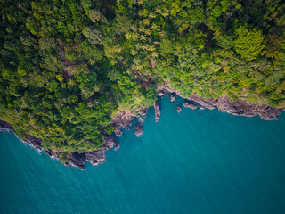Aerial view sea beach wave with green tree mountain forest in tropical island