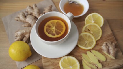 Adding lemon to cup of ginger tea. Alternative medicine herbal tea