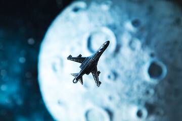 The plane flies near the moon, starry background.