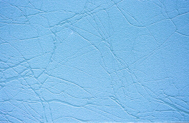 Blue background of decorative plaster with abstract spots. Unusual texture of this wall with beautiful patterns, creative surface background. Finishing coating for building cladding.